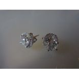 Pair of 18ct white gold stud earrings, the centre brilliant cut diamonds with detatchable surrounds,