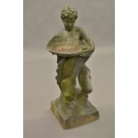 Lead garden bird bath in the form of a crouching boy supporting a bowl,