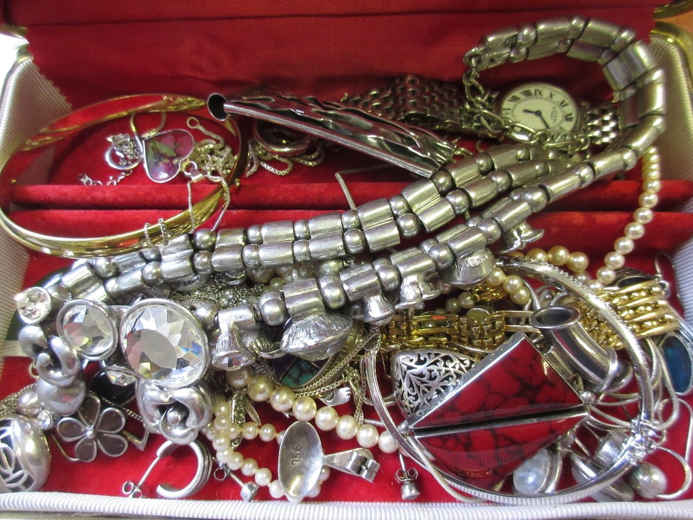 Red jewellery box containing various silver and other jewellery