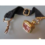 9ct Gold mounted ribbon fob with a gilt cornelian set seal