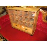 19th Century pine table top desk cabinet having pigeon holes above two short drawers with ebonised