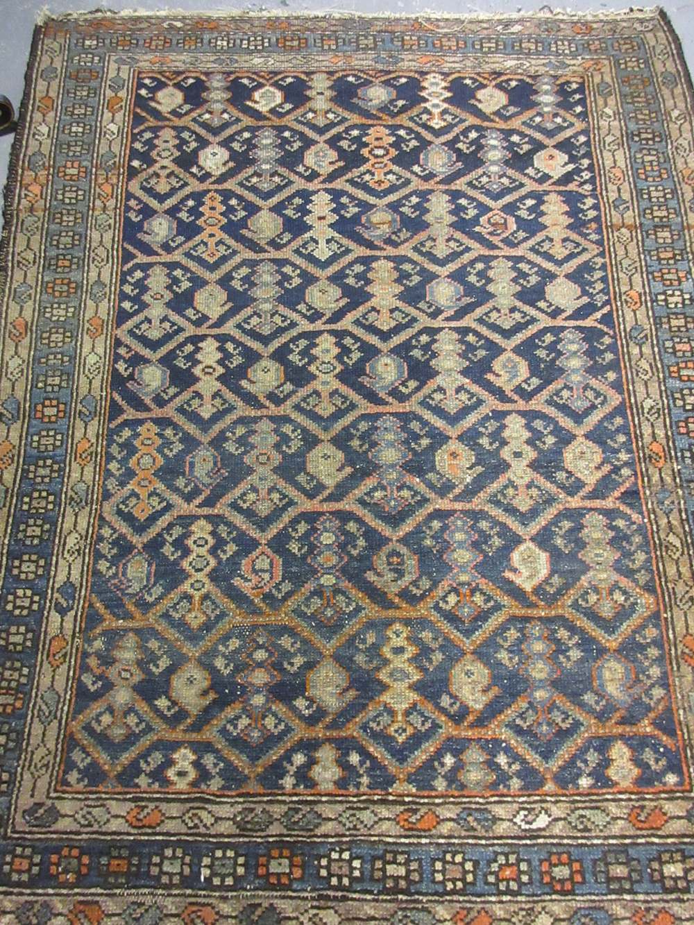 Small Kurdish rug with an all-over stylised design on a blue ground,