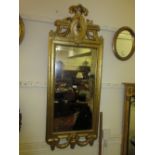 Rectangular gilt framed wall mirror in antique style with a shaped surmount above a two part