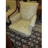 Two reproduction upholstered elbow chairs raised on turned front supports