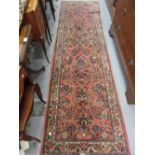 Indo Persian runner with all-over floral design and multiple borders on a pink ground,