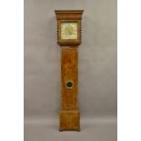 Figured walnut longcase clock with square hood with moulded cornice and fretwork frieze above