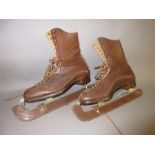 Pair of 20th Century ice skates with integral leather boots