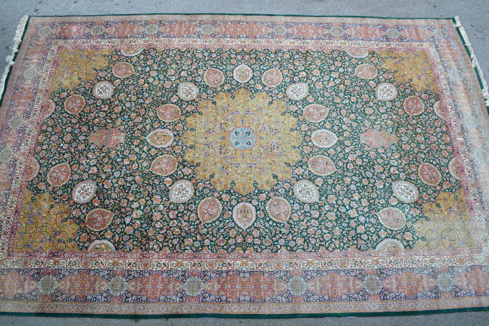 Tabriz carpet with lobed medallion and all-over floral design on a green ground with corner designs