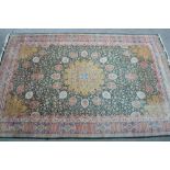 Tabriz carpet with lobed medallion and all-over floral design on a green ground with corner designs