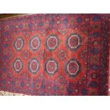 Modern Afghan Belouch rug with two rows of four gols on a wine ground with borders and Kelim ends,