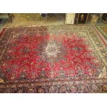 Meshed carpet with lobed medallion and all-over floral design on a red ground with borders,