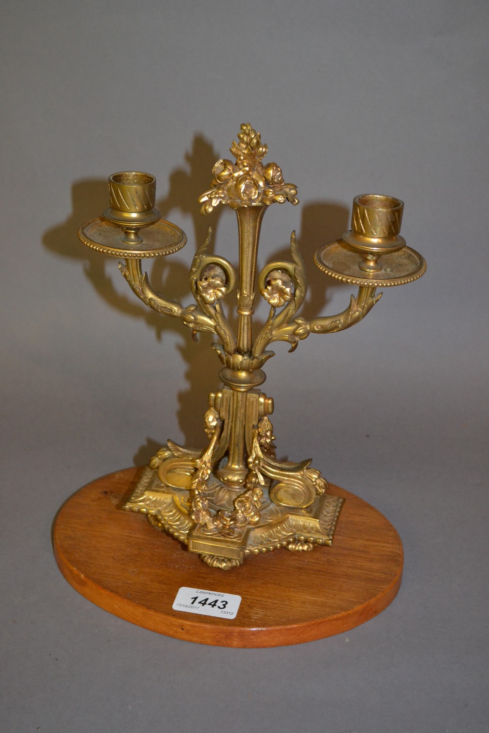Good quality 19th Century ormolu twin light candelabra mounted on an oval walnut base
