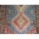 Small South West Persian rug with a triple hooked medallion design on a polychrome ground with