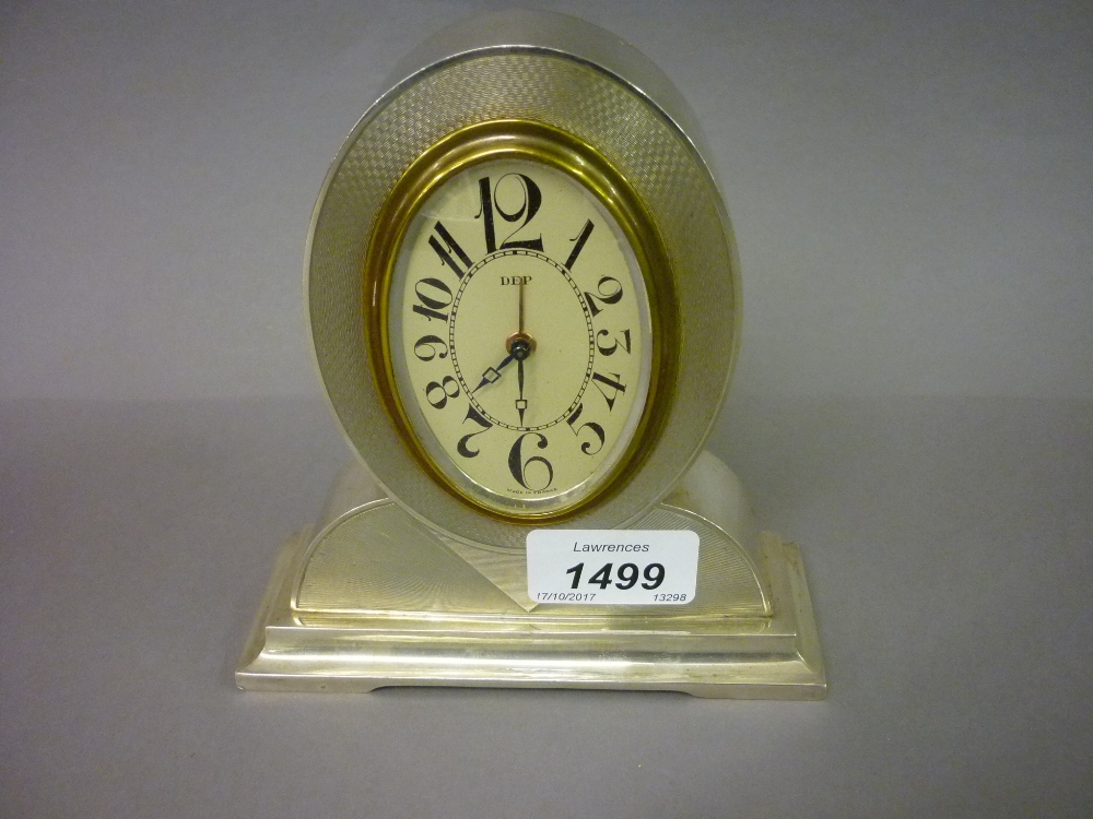 Continental silver (900 mark) mantel or dressing table clock of Art Deco design with an oval dial,