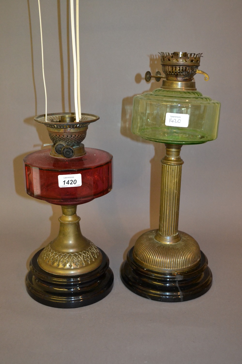 Cranberry glass and brass oil lamp adapted for use with electricity,