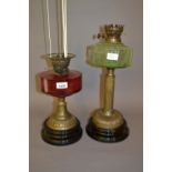 Cranberry glass and brass oil lamp adapted for use with electricity,