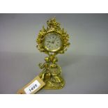 Unusual small cast brass mantel timepiece in the form of seated figures beneath a tree,