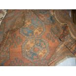 Afghan Belouch carpet with three rows of seven gols on a rust ground with borders,