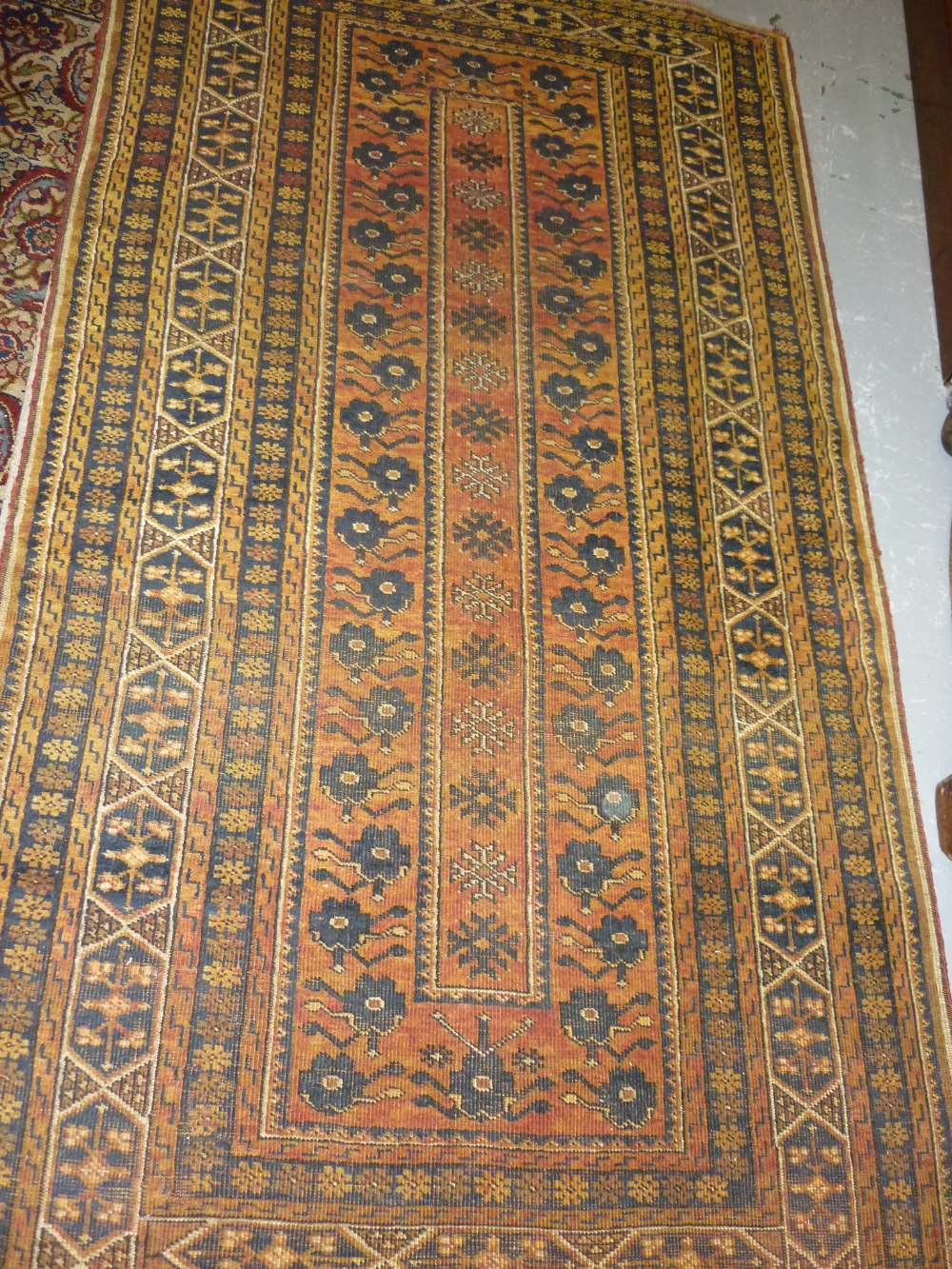 Small Afghan gold ground rug with a single central floral panel and multiple borders,