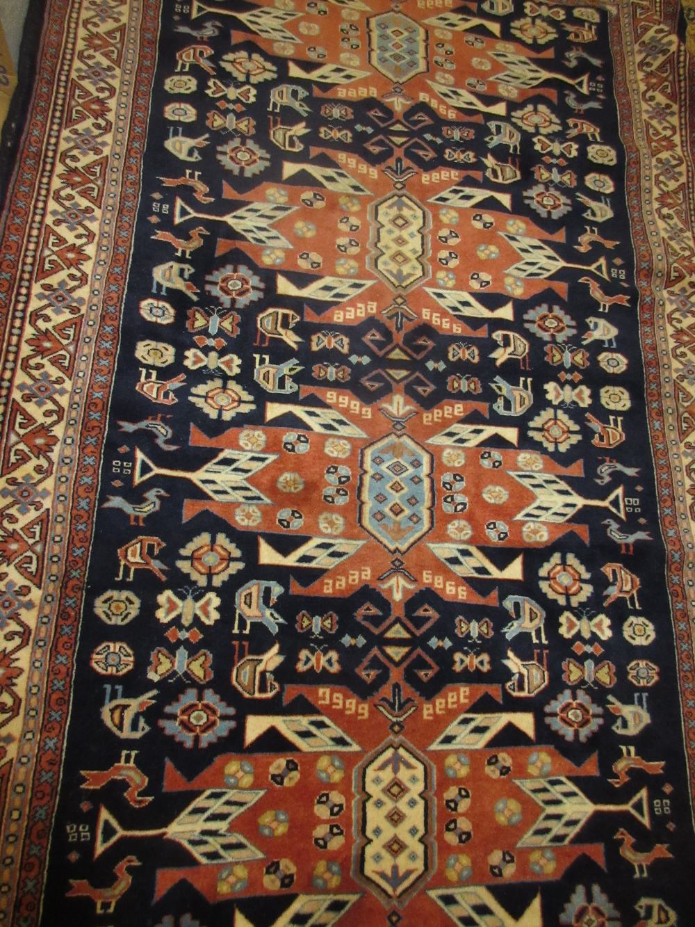 Indo Persian rug having all-over geometric birds and floral design with multiple borders on a dark