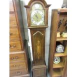 Early 20th Century mahogany marquetry and inlaid Grandmother clock with an arched hood above