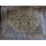 Persian rug having all-over floral decoration on a beige ground with multiple borders,