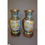 Pair of 20th Century Chinese floral decorated cloisonné baluster form vases on hardwood stands