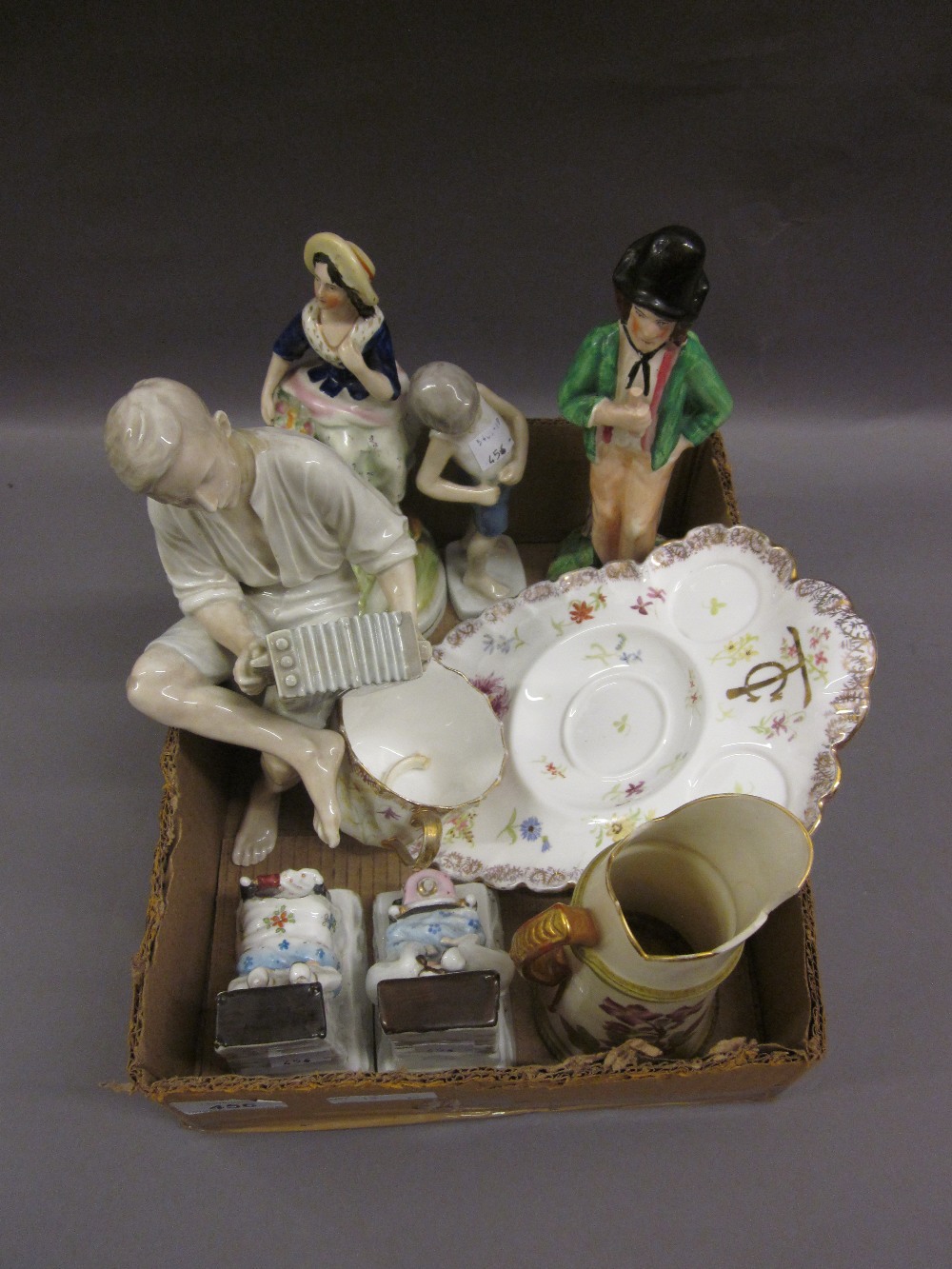 Staffordshire figure ' Gin and Water ', together with another of a girl with a basket of flowers,