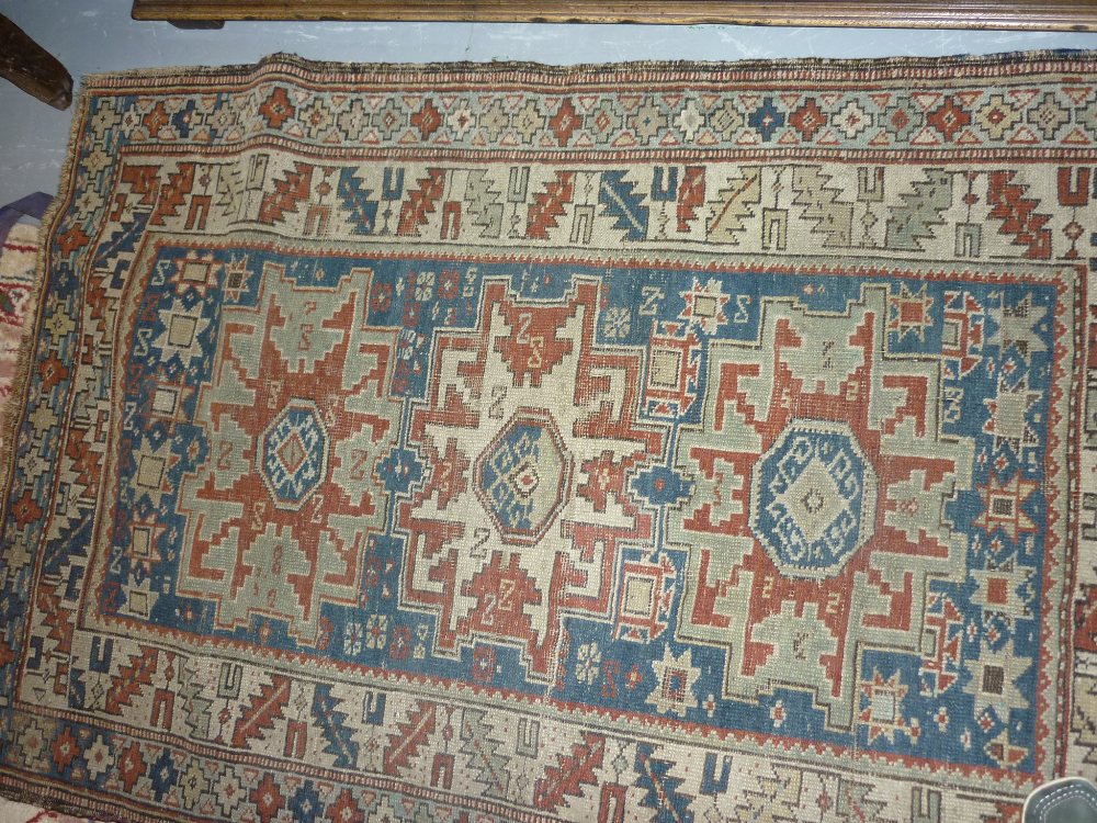 Small Kazak rug with a triple medallion design on a blue ground with multiple border,