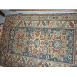 Small Kazak rug with a triple medallion design on a blue ground with multiple border,