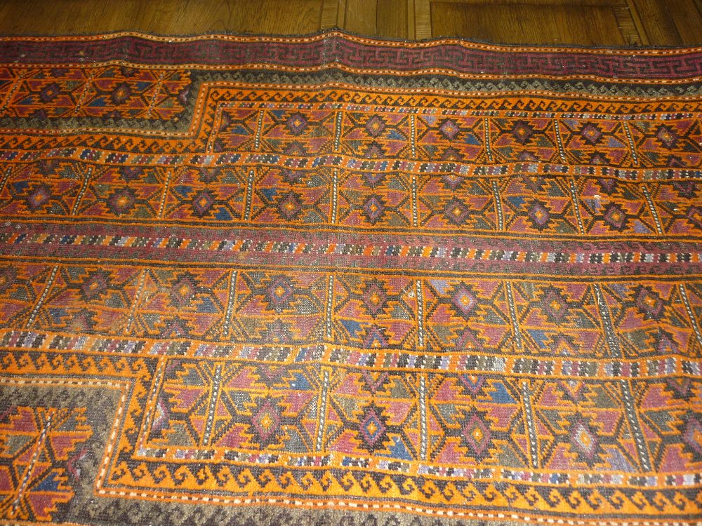 Small Belouch prayer rug with an all-over geometric design in shades of orange and claret,