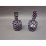 Pair of glass decanters with red and blue swirl decoration