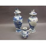 Two 19th Century Chinese blue and white baluster form vases with covers (one a/f) together with a