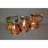 Group of three 19th Century copper measures and a swing handled copper pot