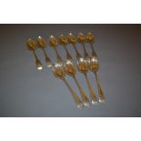 Set of seven Victorian silver Fiddle pattern dessert spoons together with four 20th Century silver