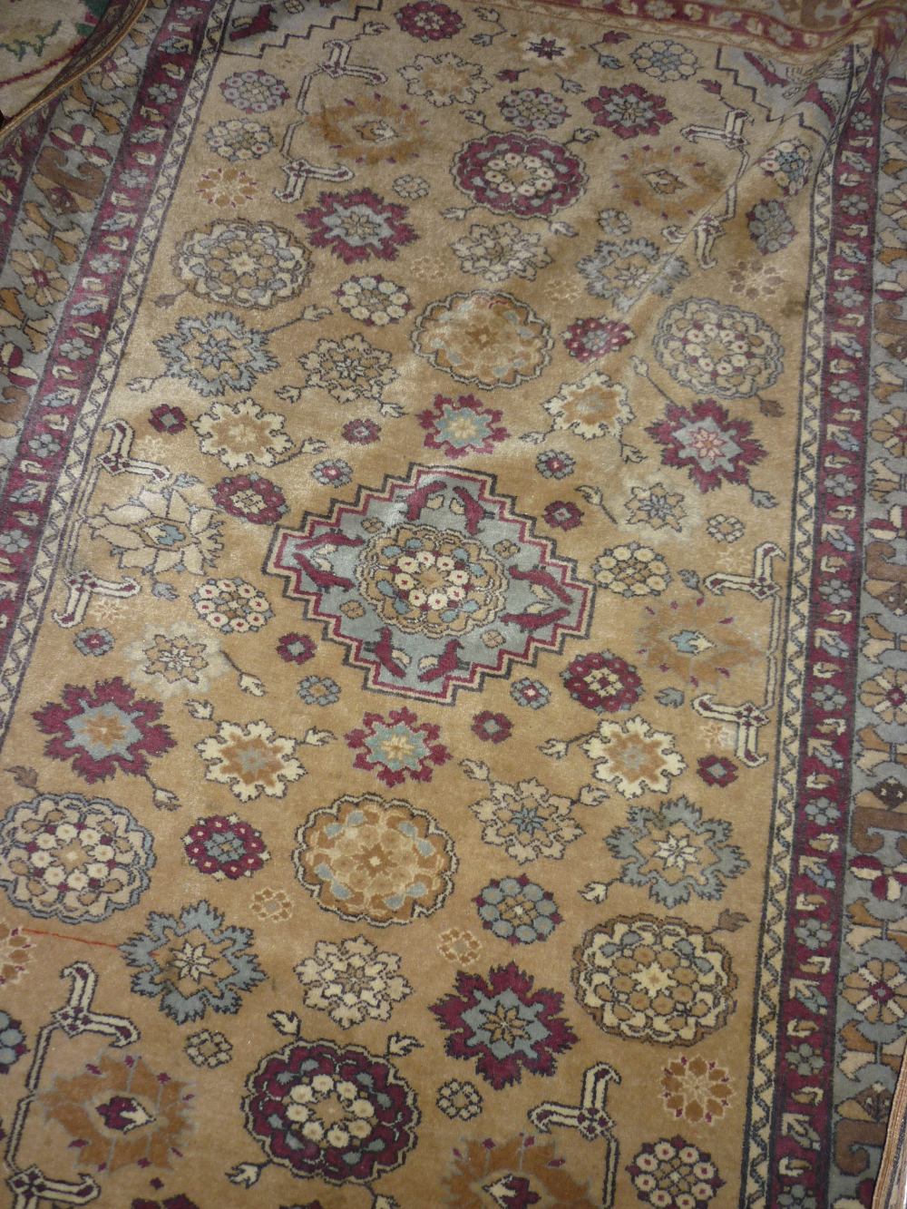 Indo Persian rug with an all-over rosette design in shades of claret and pale blue on a beige
