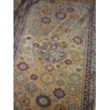 Indo Persian rug with an all-over rosette design in shades of claret and pale blue on a beige