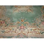 Small Chinese carpet with floral design on pale green ground with borders,