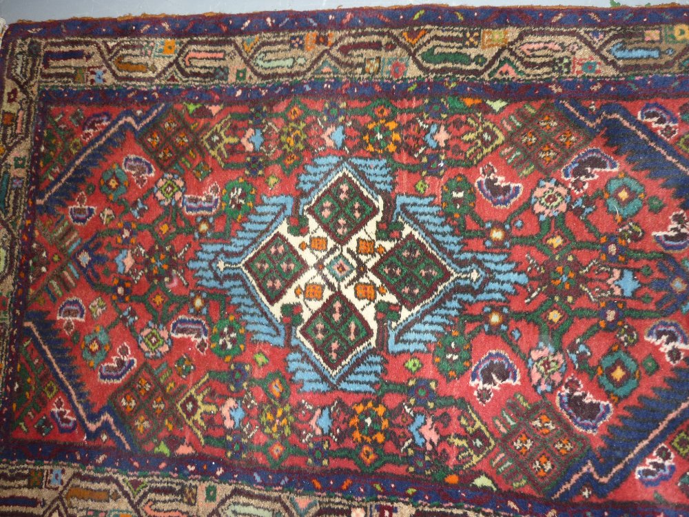 Small Hamadan rug with central medallion and all-over Herati design on a red ground,