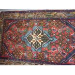 Small Hamadan rug with central medallion and all-over Herati design on a red ground,