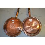 Two 19th Century copper warming pans with turned wooden handles