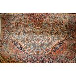 Indo Persian rug with a medallion and all-over stylised floral design on an ivory ground with