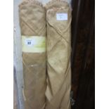 Two large rolls of gold colour silk type fabric,