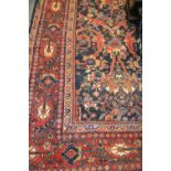 Large Kurdish carpet of all-over floral design with multiple borders on a midnight blue ground,