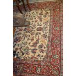 Small Tabriz carpet with an all-over stylised floral design on an ivory ground with borders,