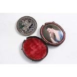 A 19TH CENTURY ENAMELLED COPPER MINIATURE PORTRAIT OF A YOUNG LADY wearing a lace-trimmed blue dress
