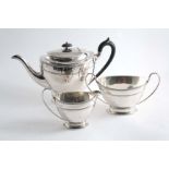A THREE PIECE TEA SET with navette-shaped bodies, loop handles & reeded borders, by James Dixon &