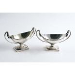 A PAIR OF GEORGE III PEDESTAL SALTS with navette-shaped bowls and upswept scroll handles, with