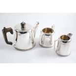 A THREE PIECE TEA SET with tapering circular bodies, gadrooned bases and angular handles, by