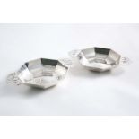 A MATCHED PAIR OF ART DECO DISHES with shallow octagonal bowls and flat, pierced handles, by E.